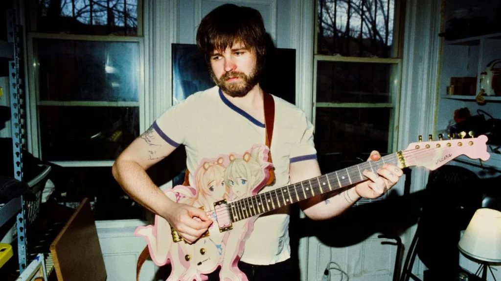 Nate Amos of This Is Lorelei holding a guitar