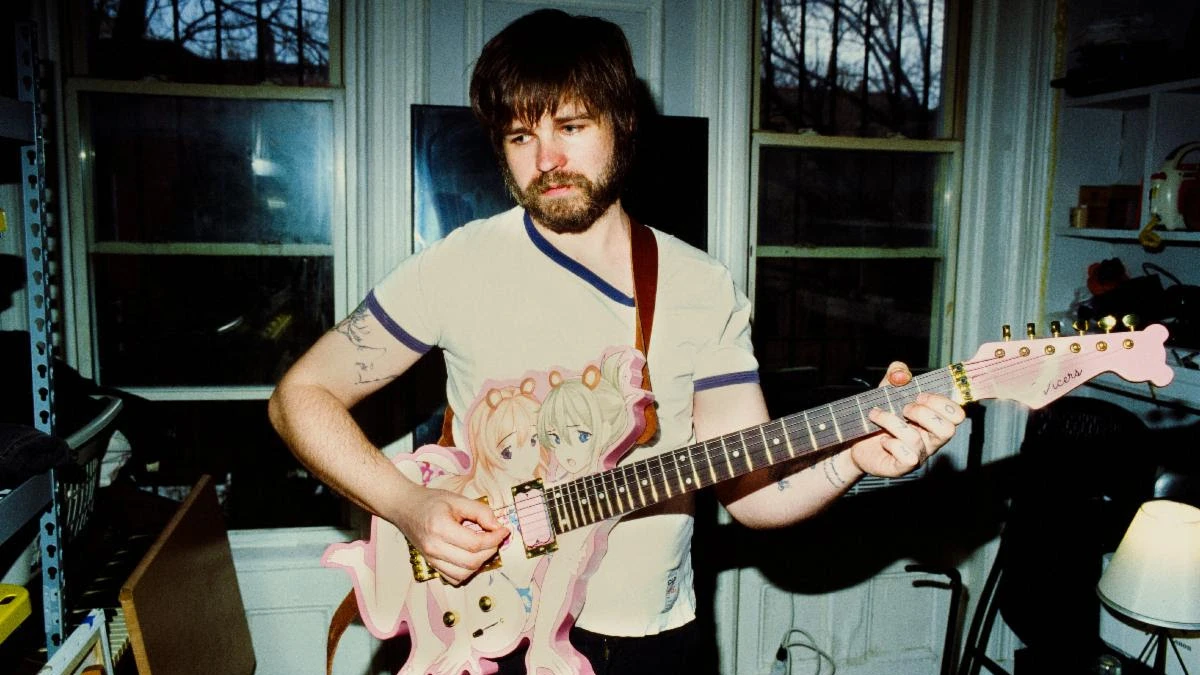 Nate Amos of This Is Lorelei holding a guitar